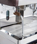 Close-up of Venezia II One Group Commercial Espresso Machine With 110V 120V Power 2000W Pro Style Boiler For Fast Steam And Consistent Shots Built Tough In Stainless Ideal For Small Cafes And Busy Offices showing its stainless drip tray and steam wand.
