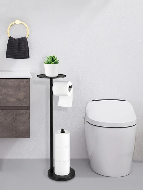 Free Standing Black Toilet Paper Holder Stand With Phone Shelf And Built In Storage, 4 Roll Capacity next to modern toilet.