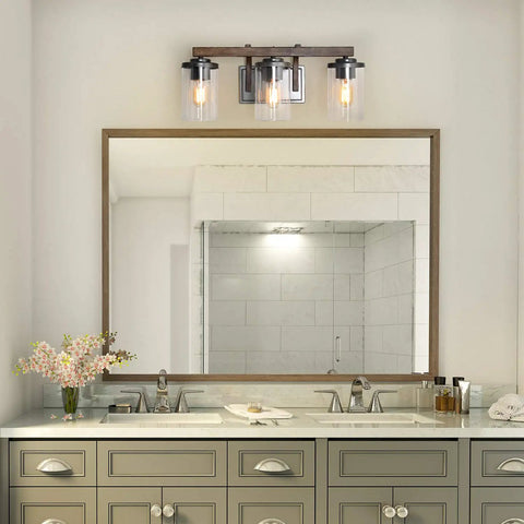 Rustic Faux Wood Three Light Farmhouse Vanity Light With Clear Glass Shades Distressed Black Backing And Decorative Panels
