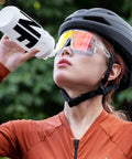 Cyclist drinking from Leak Resistant Squeeze Lid Water Bottle For Biking And Hiking, Lightweight Sports Bottle with Wide Mouth