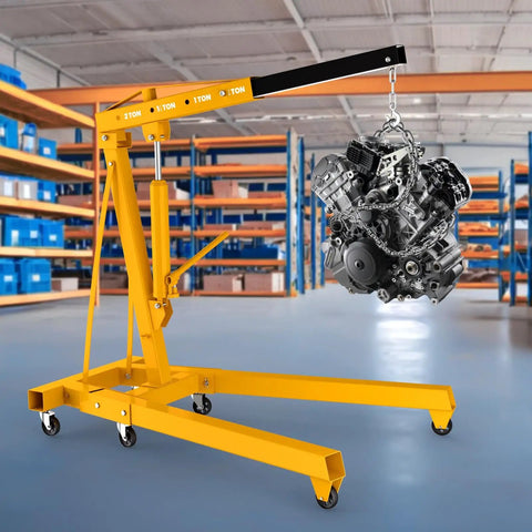 No Nonsense Heavy Duty Folding Engine Hoist Cherry Picker with 59 inch boom holding an engine in a garage setting.