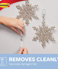 Person using Medium Clear Wire Toggle Hooks With Adhesive Strips Set Of 6 Hooks And 8 Strips For Damage Free Hangin On Walls, Doors.