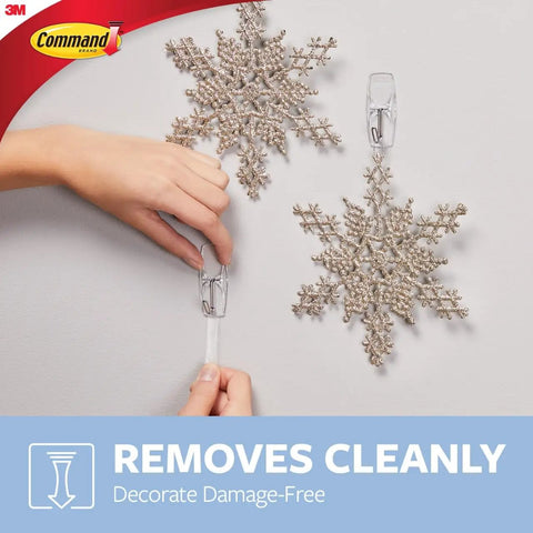 Person using Medium Clear Wire Toggle Hooks With Adhesive Strips Set Of 6 Hooks And 8 Strips For Damage Free Hangin On Walls, Doors.