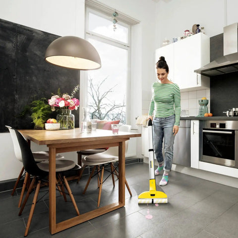 Woman using Cordless Hard Floor Cleaner With Mop Function FC 3 for wood laminate tile vinyl and stone floors in kitchen