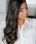 Woman with beachy waves using 1 Inch Ceramic Rotating Curling Iron With Auto Spin Wand For Effortless Beachy Waves