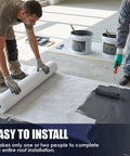 Two contractors applying High Density Stitched Polyester Roof Mesh Fabric 40 X 157.5 Ft for roof installation.