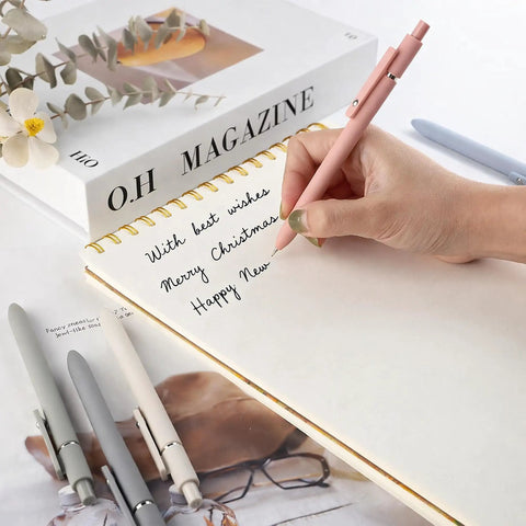 Hand writing with Go To Gel Pens Set Five Premium Retractable Gel Pens With Quick Dry Ink Fine Point Smooth Black Ink on notebook
