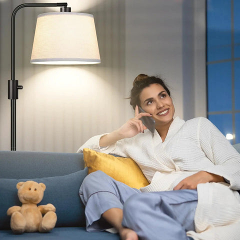 Relaxed woman on sofa under Fully Dimmable Arc Floor Lamp With 1000 Lumens LED Edison Bulb Included Modern Tall Standing Lamp