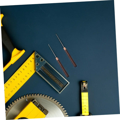 Close-up of two steel awls with wooden handles placed beside measuring tools, showcasing the 15 Piece Straight Cone Awl Set with Durable Wooden Handle for Leathercraft Sewing and Woodworking Hole Punch Projects Makes Nifty Marks with Slick Precision Every Time You Need a Go-To Tool to Whip Up Custom Crafts in No Time.