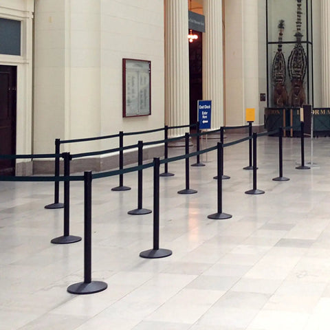 Pro Grade Stanchions 2-Pack With Retracta-Belt Prime 10 Foot Retractable Belt Barrier Heavy Base Polished Stainless Steel setup in building