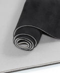 Close-up view of rolled black suede headliner fabric with foam backing.
