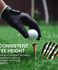 Western Birch Wood Golf Tees 100 Pack With Four Lengths 1.5 Inch, 2 Inch, 2.75 Inch, 3.25 Inch Durable Stable Tees With Smooth Surface For Men And Women Golfers Brown Gold And Green shown with glove and golf ball
