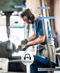 Man wearing Bluetooth Five Point Three Hearing Protection Earmuffs with NRR 25dB, working in a workshop.