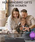 Family sitting on couch with purple Outdoor Hummingbird Feeder With Perch And Five Flower Feeding Ports 23 Oz Nectar Feeder nearby.