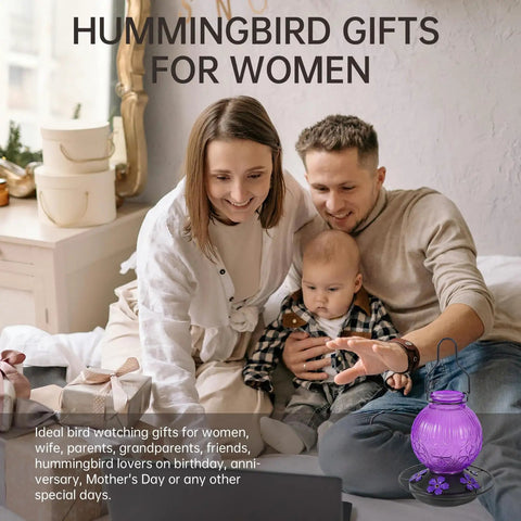 Family sitting on couch with purple Outdoor Hummingbird Feeder With Perch And Five Flower Feeding Ports 23 Oz Nectar Feeder nearby.