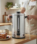Person holding 100 Cup Commercial Coffee Urn And Hot Water Boiler With Dual Wall Insulation Keeps Coffee Hot For 24 Hours Dripless Faucet Stainless Steel Server For Offices Churches And Catering Gigs