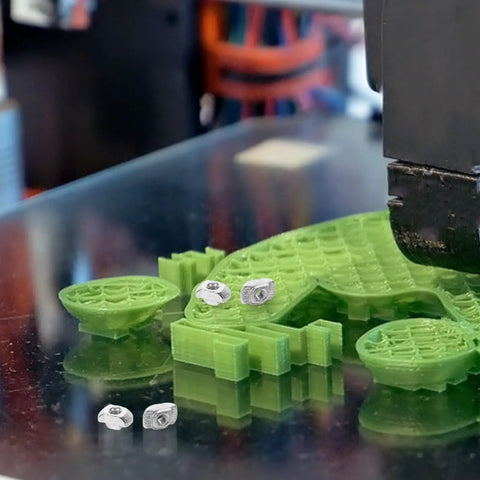 Get Your 3D Printer Building On Point With This Solid M3 Sliding T Slt Nut Kit. M3 T slot nuts with green 3D prints.