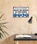 Must Wear Protective Equipment Area Aluminum Sign 8x12 Inch Durable Metal Safety Warning mounted on wall in room.