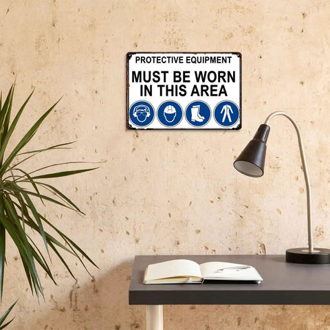 Must Wear Protective Equipment Area Aluminum Sign 8x12 Inch Durable Metal Safety Warning mounted on wall in room.