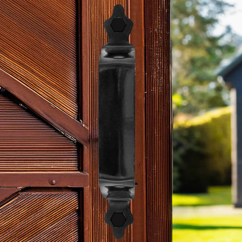 Black Decorative Six Inch Pressed Steel Gate Handle with Seven Sixteenth Inch Hex Head Mounting Screws for Wood Gates Easy to Install and Rust Resistant Gate Hardware on wooden gate outdoors.
