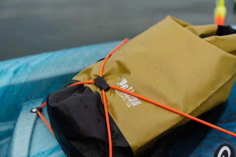 ExoDry 20L Dry Bag With Roll Top Closure on kayak, waterproof gear carrier, orange straps, black and tan color