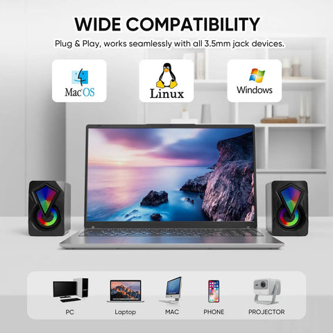 Desktop USB Powered 2.0 Computer Speakers With Volume Control And RGB LED Lights next to a laptop, compatible with PC, Mac, Linux.