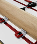 Inline Clamps T Track Clamp Two Pack With Cam Stops for woodworking in use with wooden board on red T-track system.