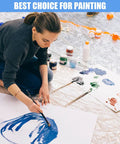 Artist painting on floor covered with 30 Pack Clear Plastic Drop Cloths For Painting, Waterproof And Dustproof Protection, Heavy Duty 9x12 Feet Tarps For Floors, Furniture, And Projects, Transparent Poly Drop Sheets.