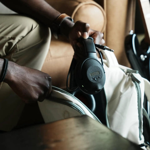 Dope Tone Wired Smart Guitar Headphone Amp With Custom Audio Drivers being placed in a bag, showing portability.