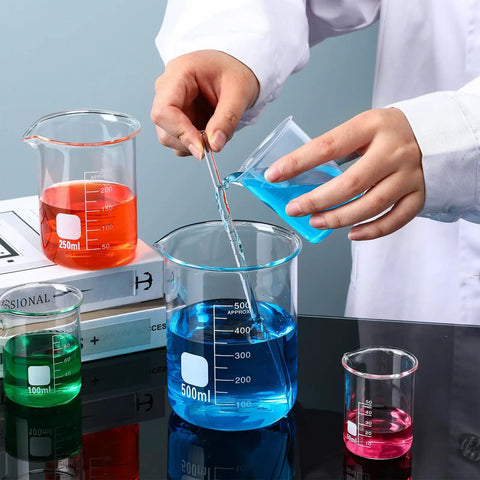 Person using Borosilicate Glass Beaker Set With Stirring Rod For Lab Chemistry 4 Sizes 50 Milliliters 100 Milliliters 250 Milliliters 500 Milliliters Thick Durable Glassware For Science Experiments And Lab Supplies Must Have with colored liquids.