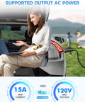 Woman using laptop at an outdoor camp setting with Vehicle To Load Adapter For Hyundai Ioniq 5 Ioniq 6 And Kia EV6.