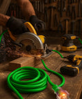 Heavy Duty Outdoor Extension Cord 50 Foot 10 Gauge 3 Prong SJTW Cable With Lighted Ends powering a circular saw in workshop