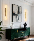 Natural Alabaster Wall Sconces Set Of Two Cylinder LED Wall Lights With Matte Black Metal Base Modern Smooth Glow For Living Room Bedroom And Bathroom mounted beside abstract art.