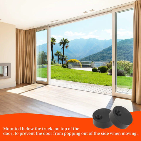 Four Piece Barn Door Stopper Set with black anti jump pads installed on sliding door track in a bright room with mountain view.