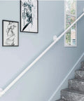 Modern White Indoor Outdoor Railing Kit Adjustable 1ft To 20ft built tough along staircase wall with wrought iron details.