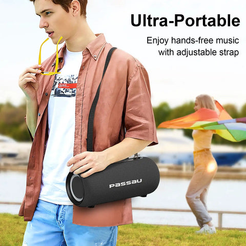 Man holding Portable Bluetooth Speaker With 40W Peak Power And Deep Bass From Dual Passive Radiators on adjustable strap outdoors.