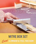Front view of a 6-inch metal mitre box with aluminum and steel construction; hand guiding a razor saw through wood block