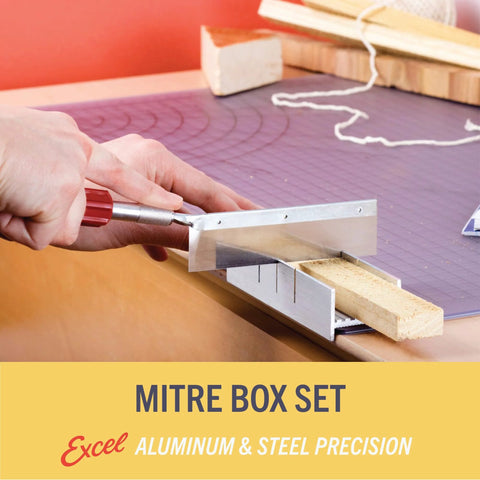 Front view of a 6-inch metal mitre box with aluminum and steel construction; hand guiding a razor saw through wood block