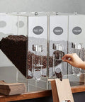 Kick Up Your Snack Station Game With This 9 Lb Acrylic Dry Food Dispenser 3 Pack Clear Bulk Bin for coffee beans on countertop.