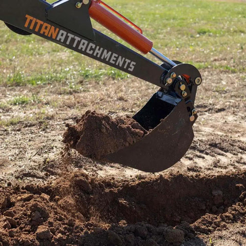 24 Inch Front And Backhoe Bucket With Hydraulic Tilt digging soil, showing beefy carbon steel teeth, pro grade digging power