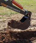 8-Inch Wide Backhoe Bucket With Three Carbon Steel Teeth in action, scooping rocky soil, shown with hydraulic tilt attachment.