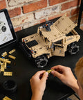 Technic RC Hummer kit being assembled on a table with instructions on a tablet, demonstrating hands-on STEM learning and creativity.