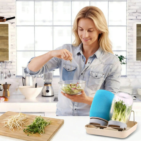 Woman using All In One Sprouting Jar Kit With 2 Wide Mouth Mason Jars Mesh Lids Blackout Sleeves Stand And Tray For Easy Home Sprouting Of Fresh Broccoli Bean And Alfalfa Sprouts In Just Days, preparing salad in kitchen.