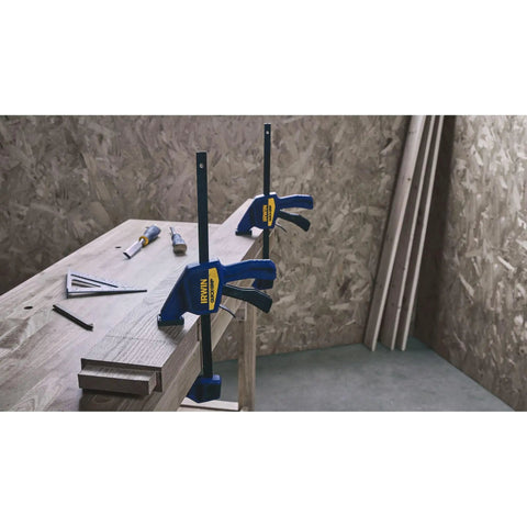 One-Handed Quick-Change Bar Clamp For Medium-Duty Projects, 12 Inch, 300 Lbs Clamping Pressure on a woodwork tabletop