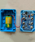 Open view of Fencing Gear Diagnostic Tool With Color-Coded Slots and Indicator Lights for blade testing, shows internal components.