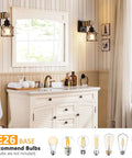 Badass Dimmable Wall Sconces Set Of Two With Rotary Switch And Black Metal Cage With Wooden Post Featuring Hardwired Farmhouse Wall Lamps For Your Great Home Glow in a bathroom setting with a mirror.