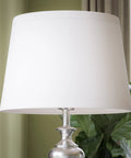 Close-up of Tall Brushed Steel Floor Lamp With Classic Style, 59 Inch Height, 15 Inch Drum Shade, in a living room setting.
