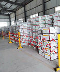 Tough As Nails Traffic Barricade Heavy Duty Industrial Crowd Control Barrier For Construction Zones And Large Gatherings Uv Resistant FRP Expandable Safety Fence Red White securing boxes in a warehouse.