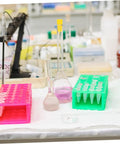 Top Tier Assorted High Temp Silicone Rubber Tapered Plug Kit With 8 Sizes For Caulking Tubes Sealing Caps Plus Flasks Test Tubes Tanks And Bottles That Stand Up To Serious Heat And Work Like A Champ. Assorted silicone plugs in pink and green racks for lab flasks and test tubes