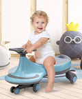 Toddler riding a blue Trendy Swing Ride On Wiggle Car With Glowing Wheels and Easy Twist Steering designed for ages 3+. Smooth indoor play.
